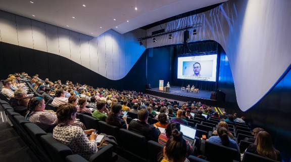 Audience at the Rainbow Chief Executives panel at the 2023 CARN conference 1. Peter Mersi from Papa Pounamu can be seen on screen