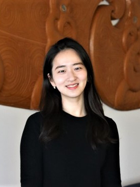 Headshot of April Kwak where she's looking at the camera and smiling