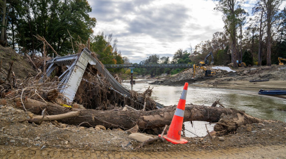 Parts of Rissington Bridge and flood debris washed up on the riverbank