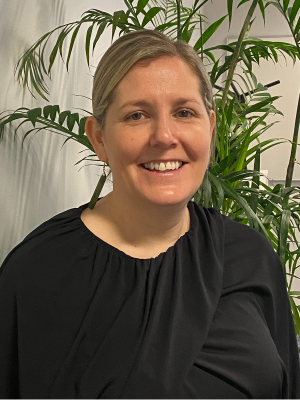 Darlene Rastrick standing in an office looking at the camera and smiling