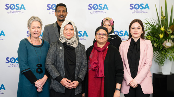 The Learning Community Hubs team standing side-by-side and smiling at the camera