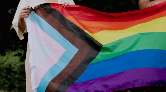 Person holding a rainbow flag