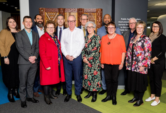 Peter Hughes Public Service Commissioner and Debbie Power Chief Executive at Ministry of Social Development standing alongside 11 of the Regional Public Service Commissioners