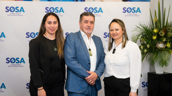 Ministry of Justice team standing side-by-side and smiling at the camera