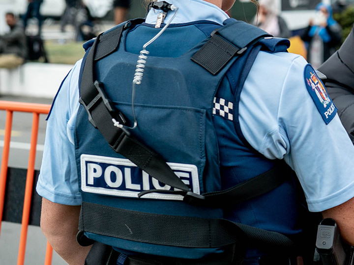 Police officer in uniform with their back facing the camera