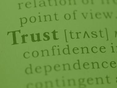 The word Trust on a green background